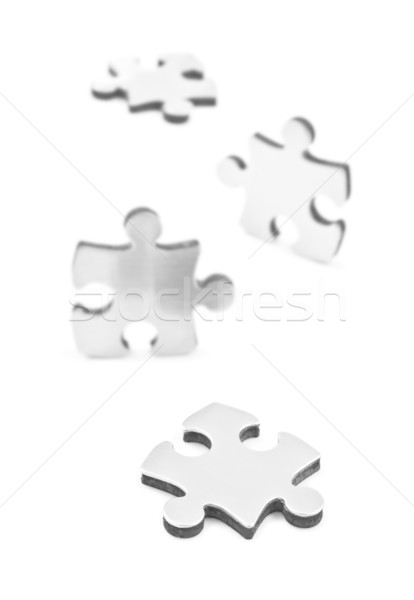 Stainless steel puzzles pieces on white background Stock photo © tish1