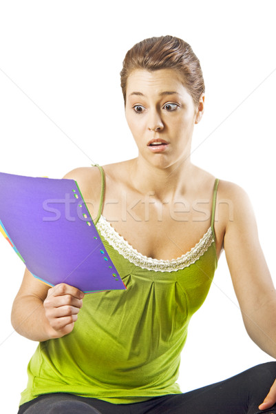 Beautiful young woman reading something shocking - white background with space for text Stock photo © tish1