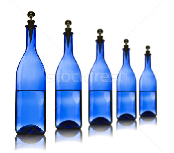 Five blue glass bottles with water Stock photo © tish1