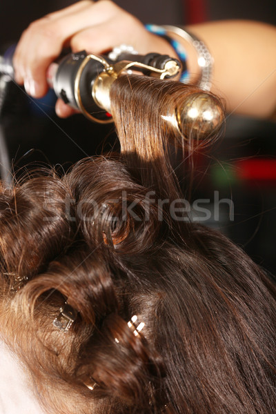 Working Hairstylist Curling Hair in a Salon Stock photo © tobkatrina