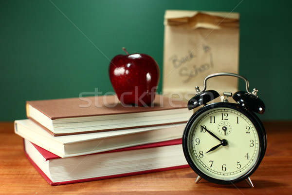 Lunch, Apple, Books and Clock on Desk at School Stock photo © tobkatrina