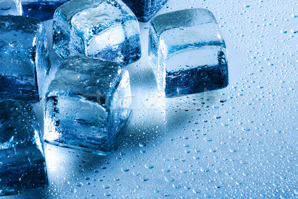 Ice cube and water drops on the wet background Stock photo © tolokonov