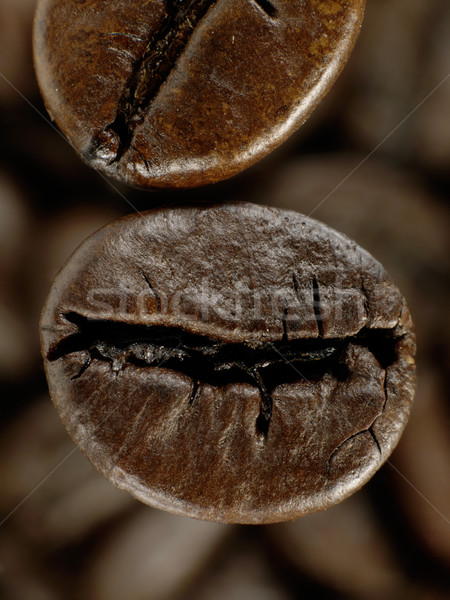 Coffee bean in deep shadows over unfocused grains background Stock photo © tolokonov
