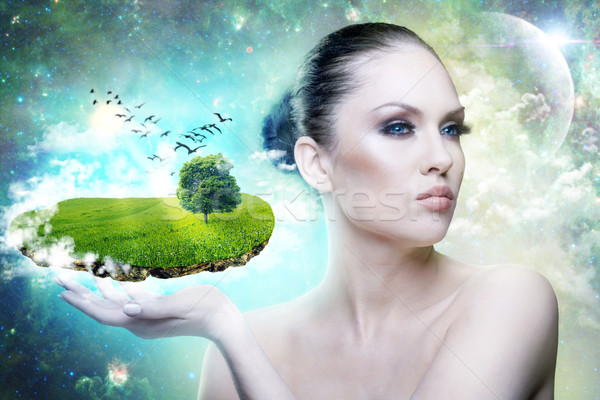 Stock photo: World of Magic. Female portrait with abstract world in hand