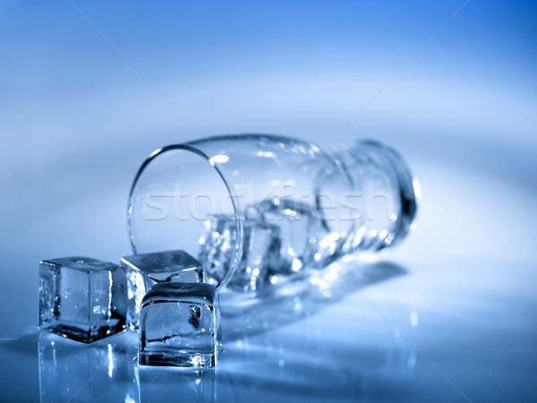 Ice cube and glass over abstract blue backgrounds Stock photo © tolokonov