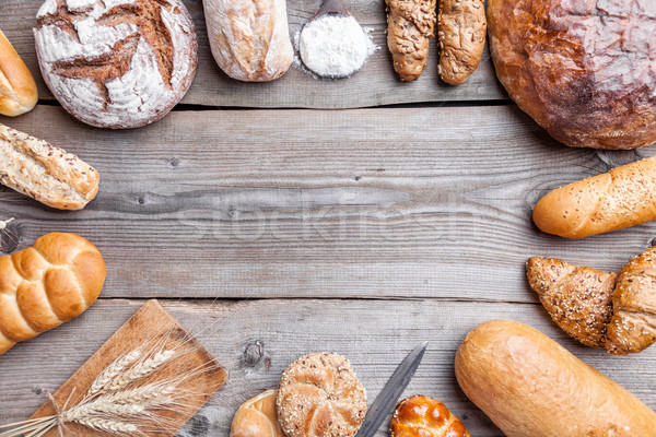 Delicious fresh bread on wooden background Stock photo © tommyandone