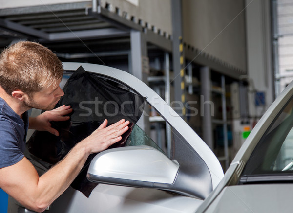 Applying tinting foil onto a car window Stock photo © tommyandone