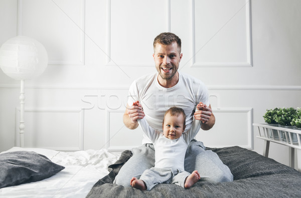 Happy father with his son playing at home on the bed Stock photo © tommyandone