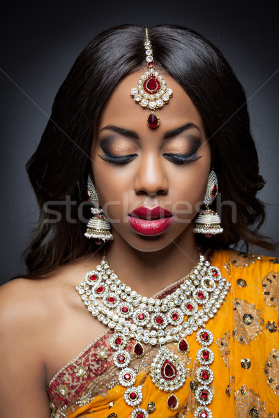 Young Indian woman in traditional clothing with bridal makeup and jewelry Stock photo © tommyandone