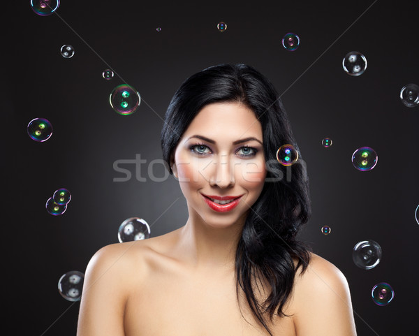 Young beautiful woman surrounded by bubbles Stock photo © tommyandone