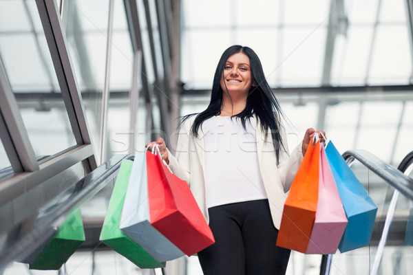 Beautiful woman leaving the mall with plenty of shopping bags Stock photo © tommyandone