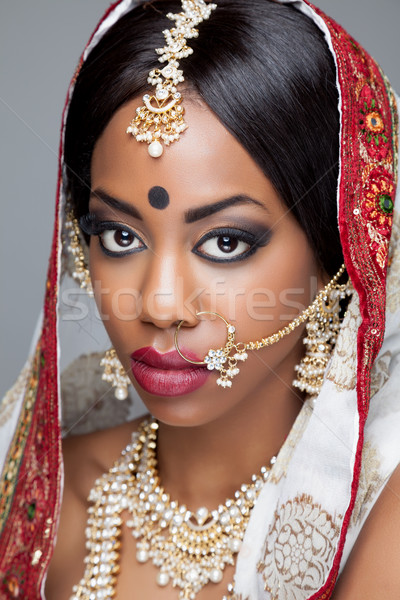 Young Indian woman in traditional clothing with bridal makeup and jewelry Stock photo © tommyandone