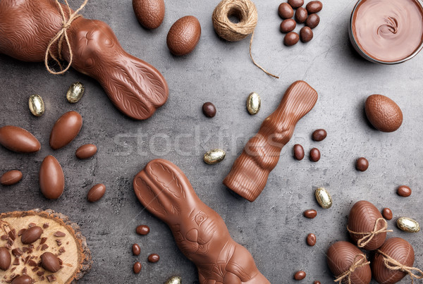 Chocolate Easter bunny, eggs and sweets on rustic background Stock photo © tommyandone