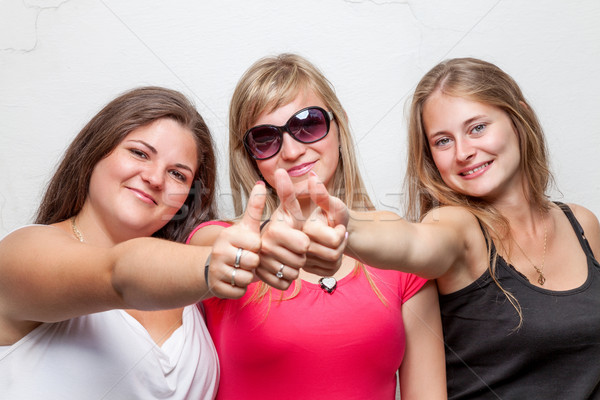 Group of happy friends giving the thumbs up Stock photo © tommyandone