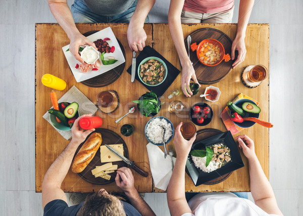 Top view, Group of people sitting at the table having meal Stock photo © tommyandone