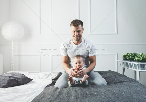 Happy father with his son playing at home on the bed Stock photo © tommyandone