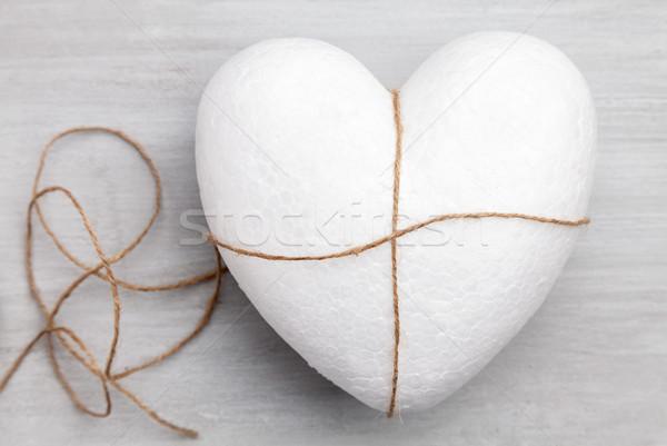 Heart bound by a string on grey background Stock photo © tommyandone