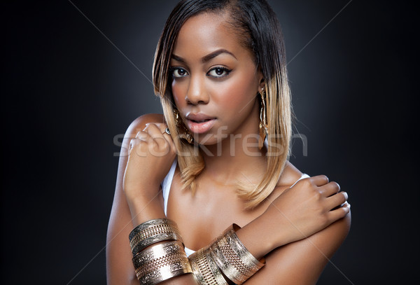 Black beauty wearing golden accessories Stock photo © tommyandone