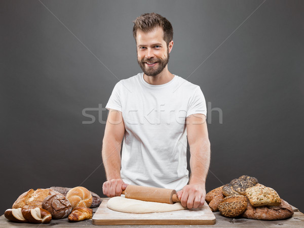 Stock photo: Baker with a variety of delicious freshly baked bread and pastry