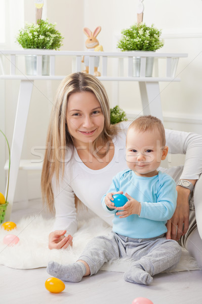 Delighted mother and her child enjoying the Easter egg hunt at home Stock photo © tommyandone