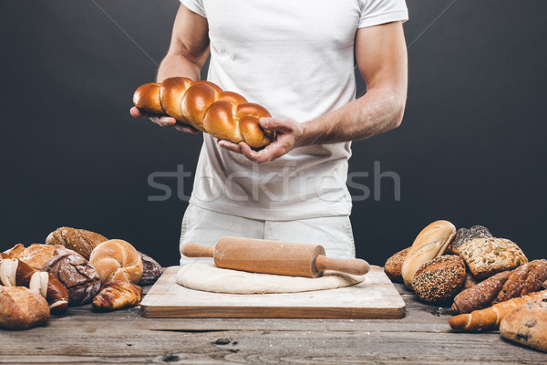 Baker with a variety of delicious freshly baked bread and pastry Stock photo © tommyandone