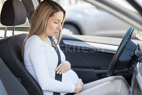 Pregnant woman behind the steering wheel having contractions Stock photo © tommyandone