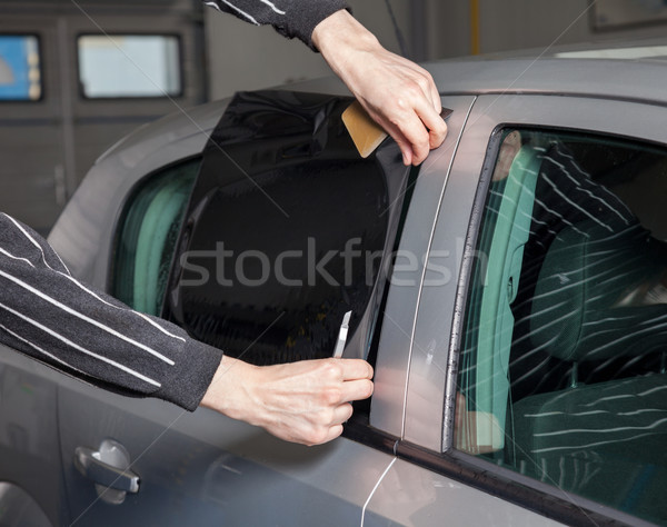 Applying tinting foil on a car window Stock photo © tommyandone