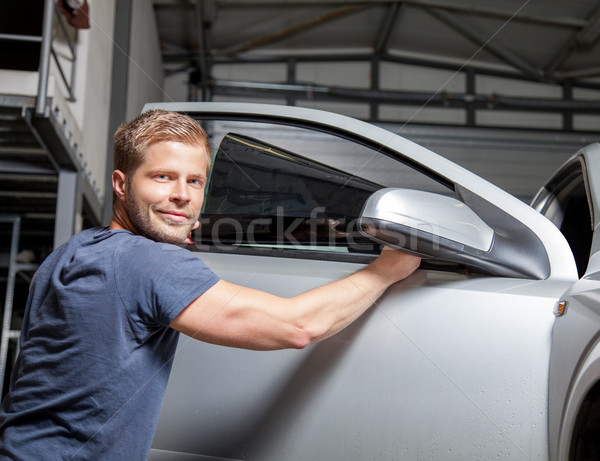 Applying tinting foil onto a car window  Stock photo © tommyandone