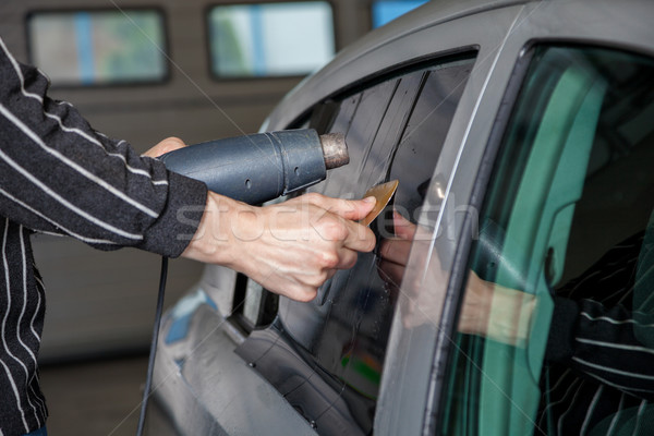 Applying tinting foil on a car window Stock photo © tommyandone