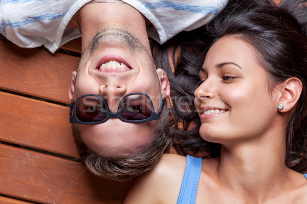 Happy young couple lying on a wooden floor Stock photo © tommyandone