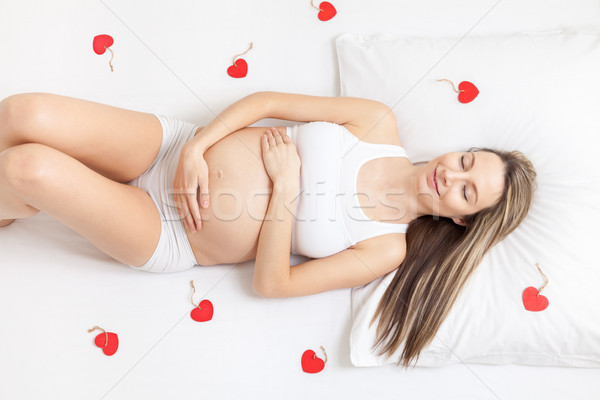 [[stock_photo]]: Femme · enceinte · détente · lit · jeunes · bébé · heureux