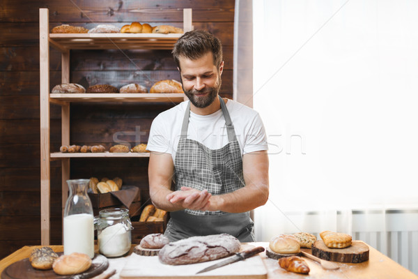 Stock photo: Baker with a variety of delicious freshly baked bread and pastry