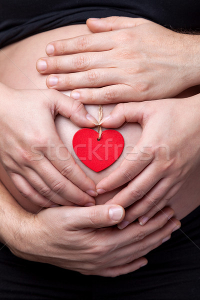Stock photo: Portrait of parents holding a pregnant belly