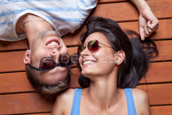 Happy young couple lying on a wooden floor Stock photo © tommyandone