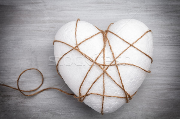 Heart bound by a string on grey background Stock photo © tommyandone
