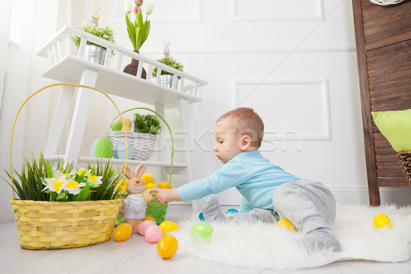 Easter egg hunt. Adorable child playing with Easter eggs at home Stock photo © tommyandone
