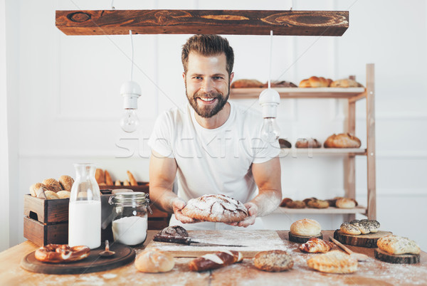 Baker with a variety of delicious freshly baked bread and pastry Stock photo © tommyandone