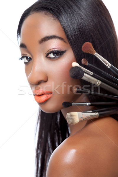Black woman with straight hair and makeup brushes  Stock photo © tommyandone
