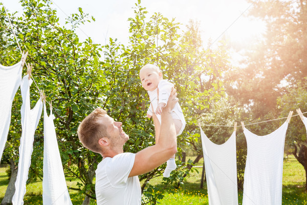 Happy father with a baby outdoors Stock photo © tommyandone