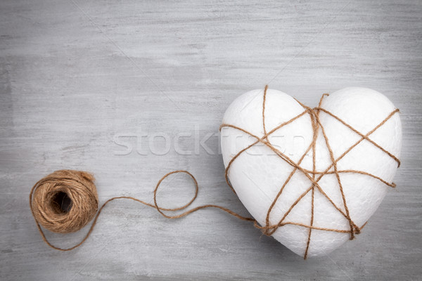 Heart bound by a string on grey background Stock photo © tommyandone