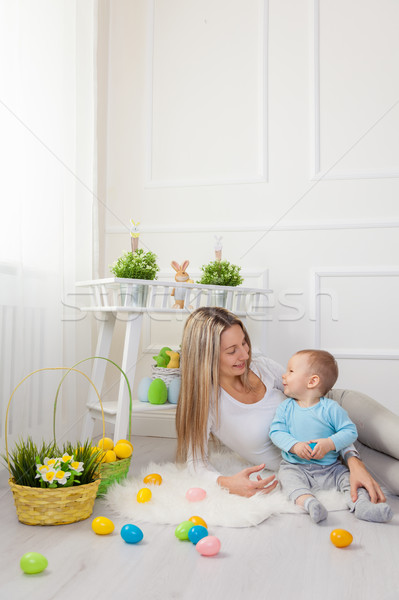 Delighted mother and her child enjoying the Easter egg hunt at home Stock photo © tommyandone