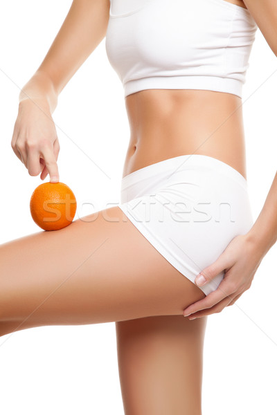Stock photo: Woman with an orange showing a perfect skin 