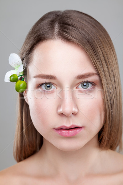 Beautiful brunette woman with a flower in hair Stock photo © tommyandone