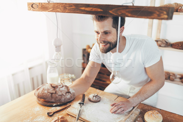 Baker with a variety of delicious freshly baked bread and pastry Stock photo © tommyandone