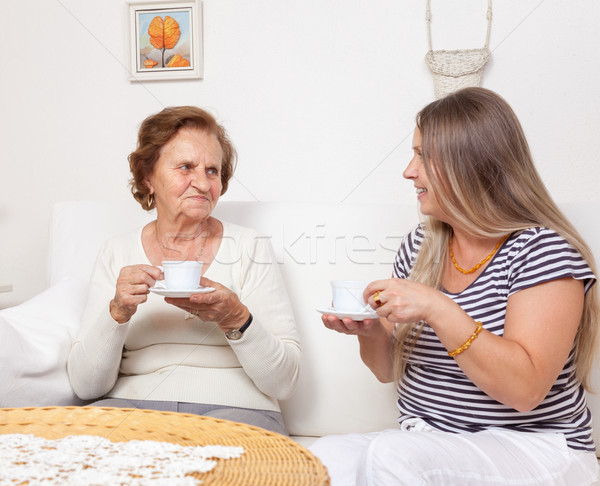 Carer having a cup of tea with an elderly woman Stock photo © tommyandone