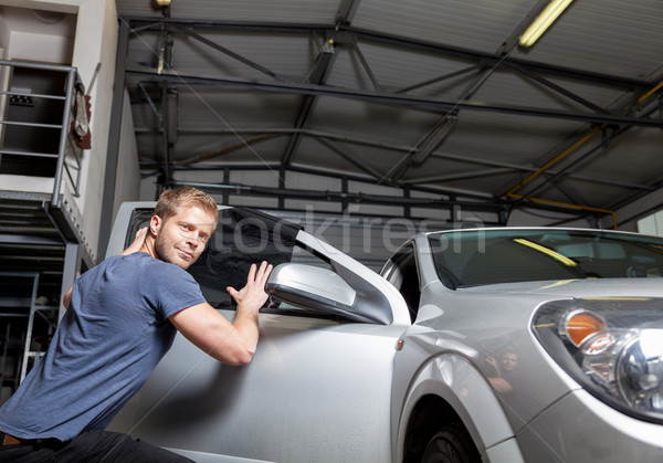 Applying tinting foil onto a car window Stock photo © tommyandone