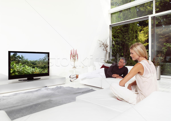 Gyönyörű pár néz tv ül kanapé Stock fotó © toocan
