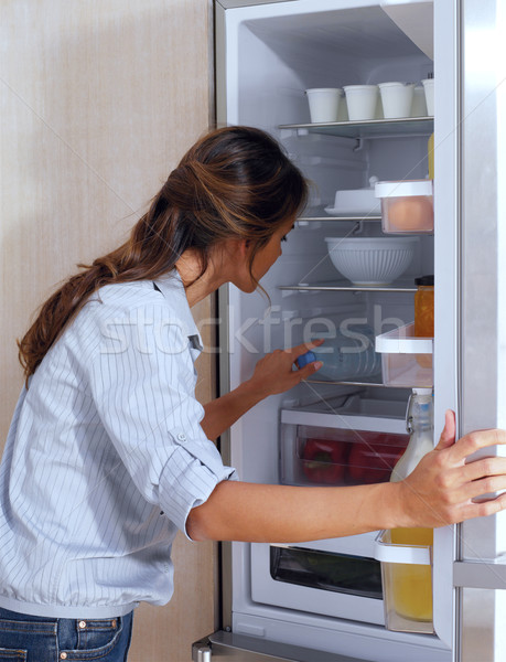 Femeie uita frigider acasă fericit Imagine de stoc © toocan