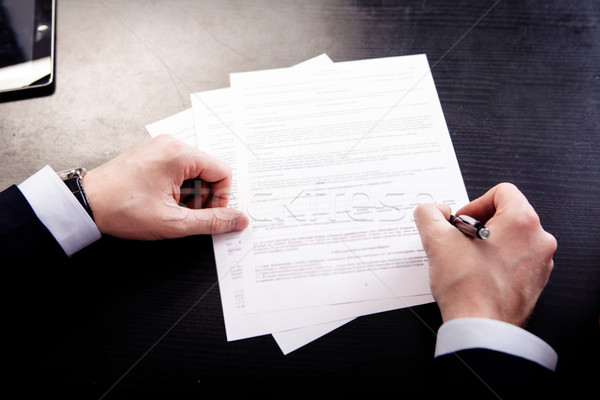 Image of human hand with pen over documents at workplace Stock photo © traza