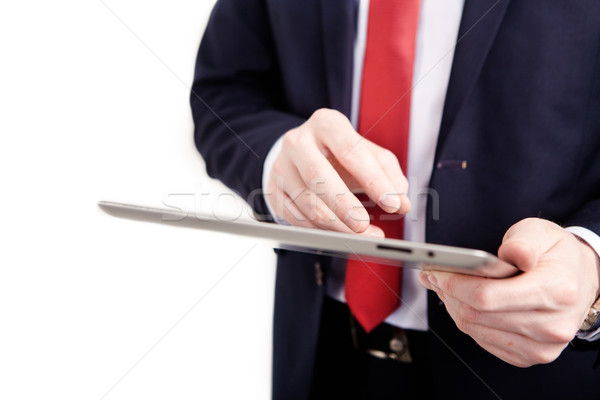 Businessman standing posture hand holding blank tablet isolated on over white background Stock photo © traza